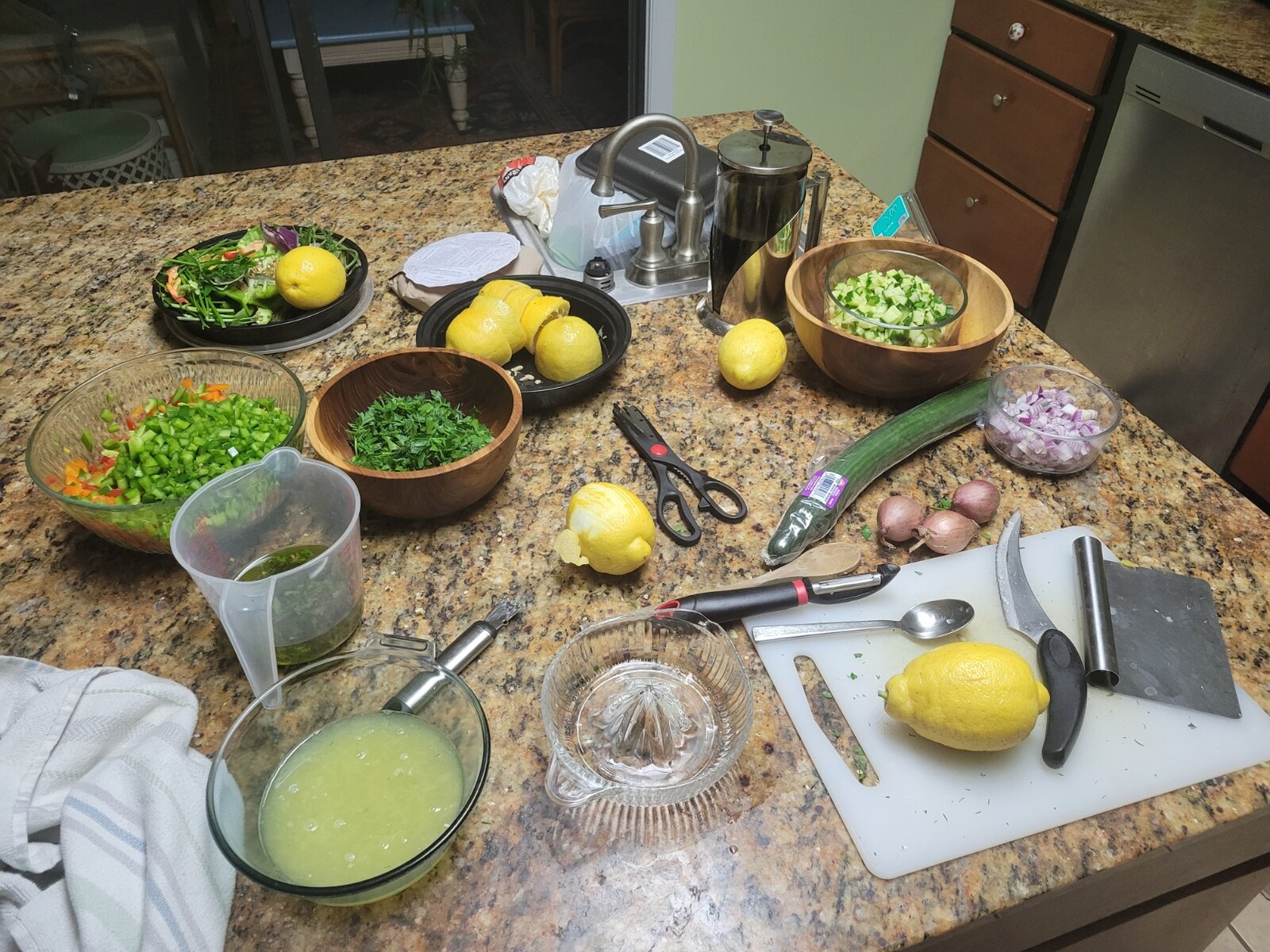 Ingredients prepped on the counter — herbs, lemons, vegetables, and tools